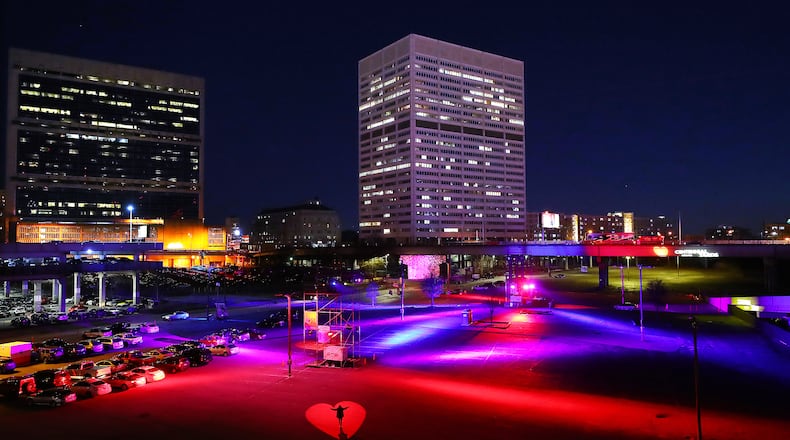 Artist/curator Courtney Hammond stands on part of the heartbeat-based art installation she helped create where Centennial Yards has turned the Gulch into a Heartbeat ATL art installation on Monday, Jan. 31, 2022, in Atlanta. People have described the area to be a ”hole in the heart" of Atlanta for years, a boring expanse of parking lots. Centennial Yards, the folks building a work-play-shop area there, teamed with some local artists to create a heartbeat-based light installation that can be triggered by a website you can got to by scanning QR codes set up around the area. Curtis Compton / Curtis.Compton@ajc.com