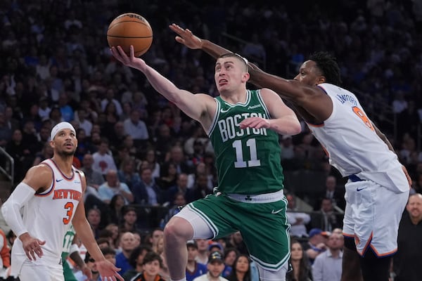 Boston Celtics' Payton Pritchard (11) drives past New York Knicks' OG Anunoby (8) during the second half of Game 6 in the Eastern Conference semifinals of the NBA basketball playoffs Friday, May 16, 2025, in New York. (AP Photo/Frank Franklin II)