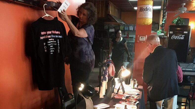 Volunteers sell Republican merchandise at a tea party meeting. Conservatives in Texas are torn over Donald Trump, but tried to rally around him at the meeting.