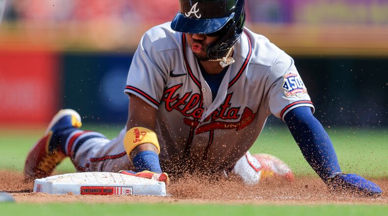 Atlanta Braves' Ronald Acuna Jr. slides safely into third base during the third inning of a baseball game against the Cincinnati Reds in Cincinnati, Saturday, June 26, 2021. (AP Photo/Aaron Doster)