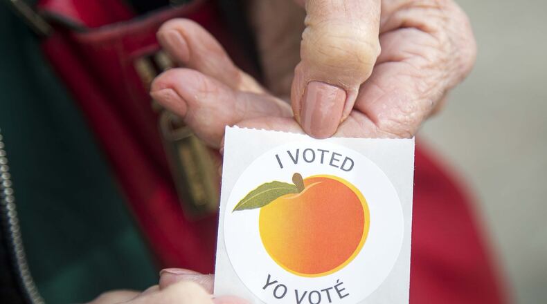 An early voter displays their “I Voted” sticker during early voting for the presidential primary at the Gwinnett Voter Registrations and Elections office building in Lawrenceville, Monday, March 2, 2020. (ALYSSA POINTER/ALYSSA.POINTER@AJC.COM)