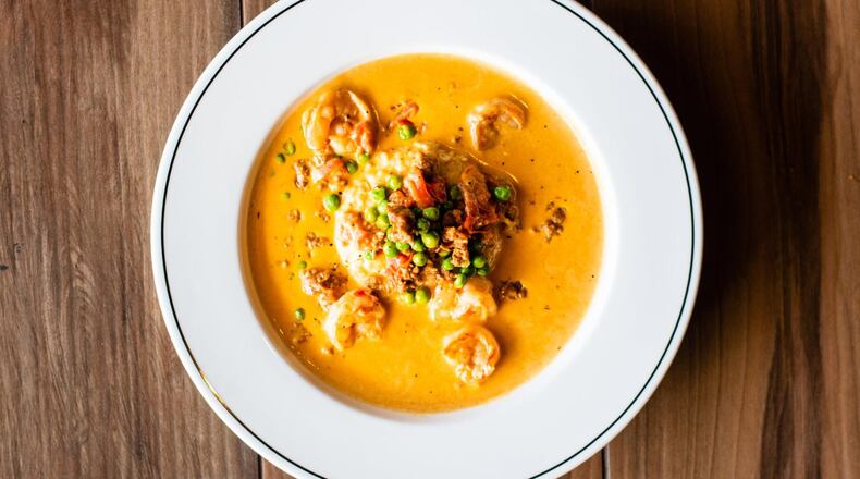 The shrimp and grits at Public Kitchen & Bar is rich and homey, made with bacon and cheddar grits smothered in rich sherry cream. CONTRIBUTED BY HENRI HOLLIS