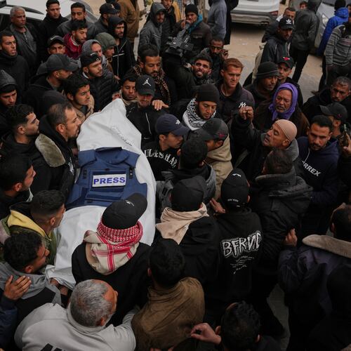 Mourners carry the body of Anas Ghoneim, one of the three Palestinian journalists who were killed in an Israeli strike on an Egyptian committee's vehicle, during his funeral in Khan Younis, southern Gaza Strip, Thursday, Jan. 22, 2026. (AP Photo/Abdel Kareem Hana)