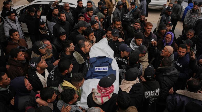 Mourners carry the body of Anas Ghoneim, one of the three Palestinian journalists who were killed in an Israeli strike on an Egyptian committee's vehicle, during his funeral in Khan Younis, southern Gaza Strip, Thursday, Jan. 22, 2026. (AP Photo/Abdel Kareem Hana)
