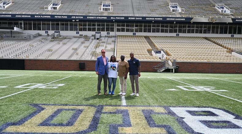Legendary quarterback Peyton Manning (left) and Georgia Tech great Morgan Burnett (right) pose for a photo with the parents of the late Demaryius Thomas, Katina Smith and Bobby Thomas, at a ceremony at Bobby Dodd Stadium Aug. 8, 2022, to honor the Tech great and Denver Broncos star. (Photo by Danny Karnik/Georgia Tech Athletics)
