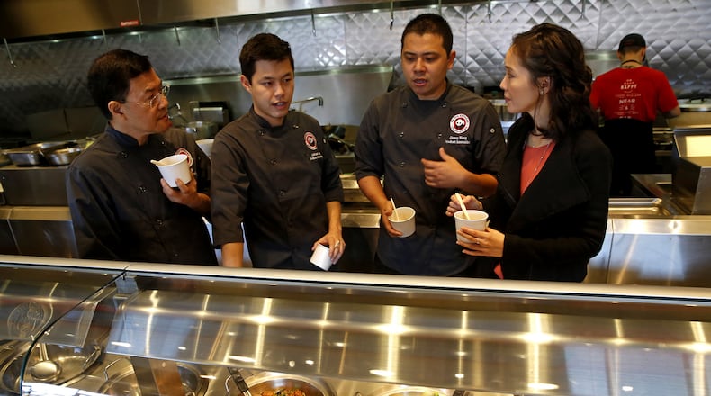 Federal authorities charged two metro Atlanta men Friday with fraud for allegedly stealing more than $1 million from California restaurant chain Panda Express with false bills for non-existent job recruits. In this 2015 photo, Panda Express’ real employees are developing new dishes in the company’s Pasadena, Calif., test kitchen. (Don Bartletti/Los Angeles Times/TNS)
