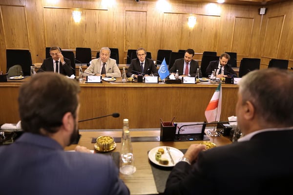 In this photo released by the Atomic Energy Organisation of Iran, International Atomic Energy Agency (IAEA) Director General, Rafael Mariano Grossi, rear center, and his delegation attend a meeting with head of the Atomic Energy Organization of Iran, Mohammad Eslami, foreground right, and his delegation in Tehran, Iran, Thursday, April 17, 2025. (Atomic Energy Organisation of Iran via AP)