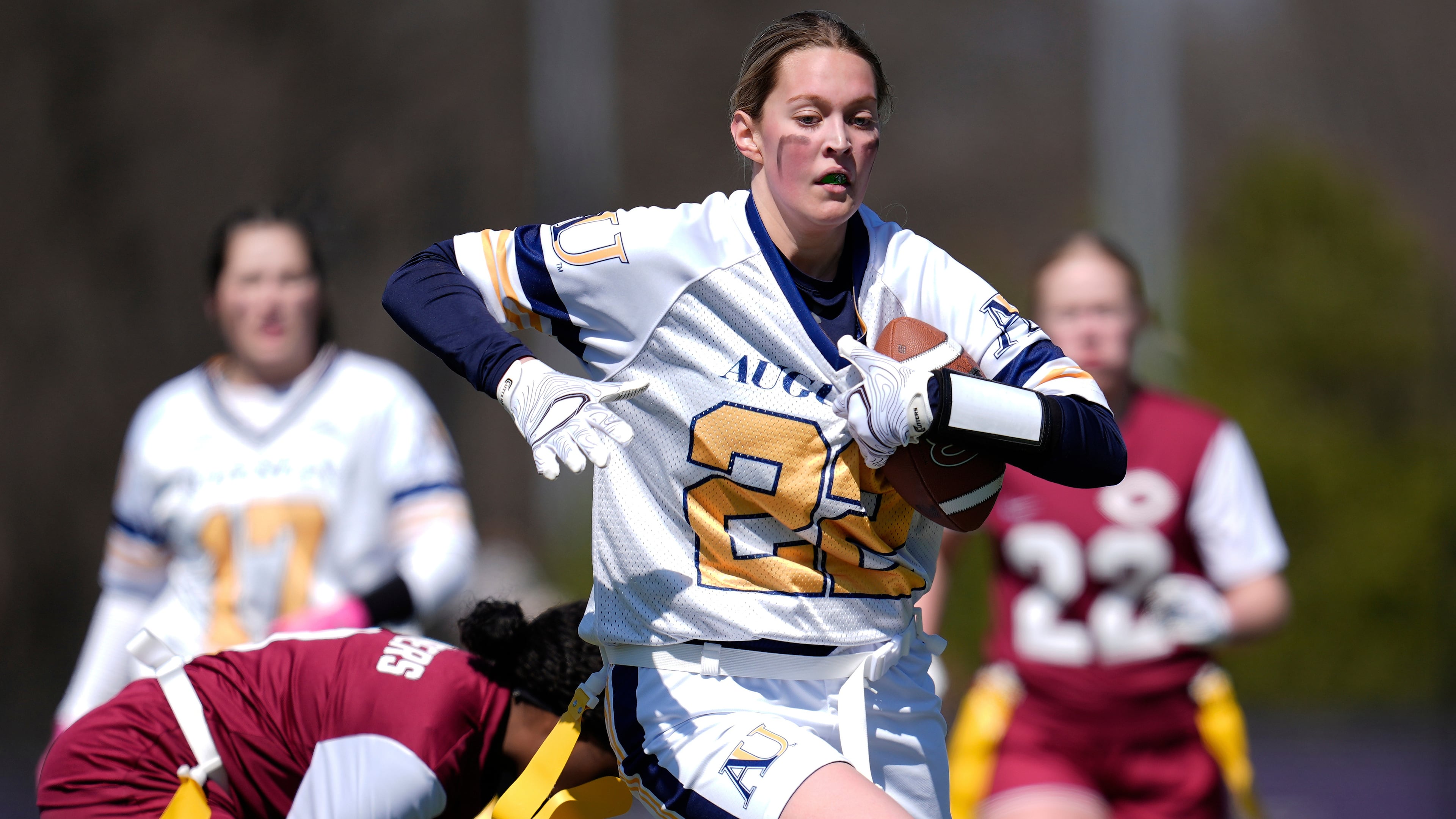 FILE - Augustana University and Concordia University, St. Paul players compete during a women's college flag football game, April 7, 2025, in St. Paul. Minn. (AP Photo/Abbie Parr, File)