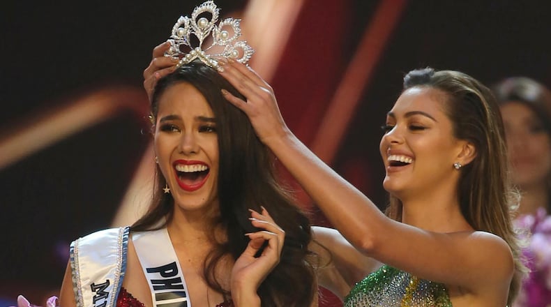 Catriona Gray of the Philippines, left, reacts as she is crowned the new Miss Universe 2018 by Miss Universe 2017 Demi-Leigh Nel-Peters during the final round of the 67th Miss Universe competition in Bangkok, Thailand, Monday, Dec. 17, 2018.