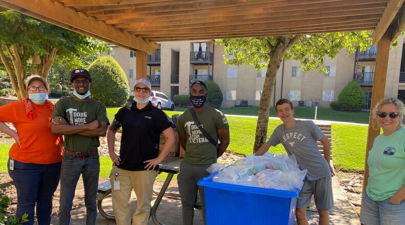 The Home Depot volunteer team and others prepare to hand out hundreds of MUST Summer Lunch meals to children in South Cobb.