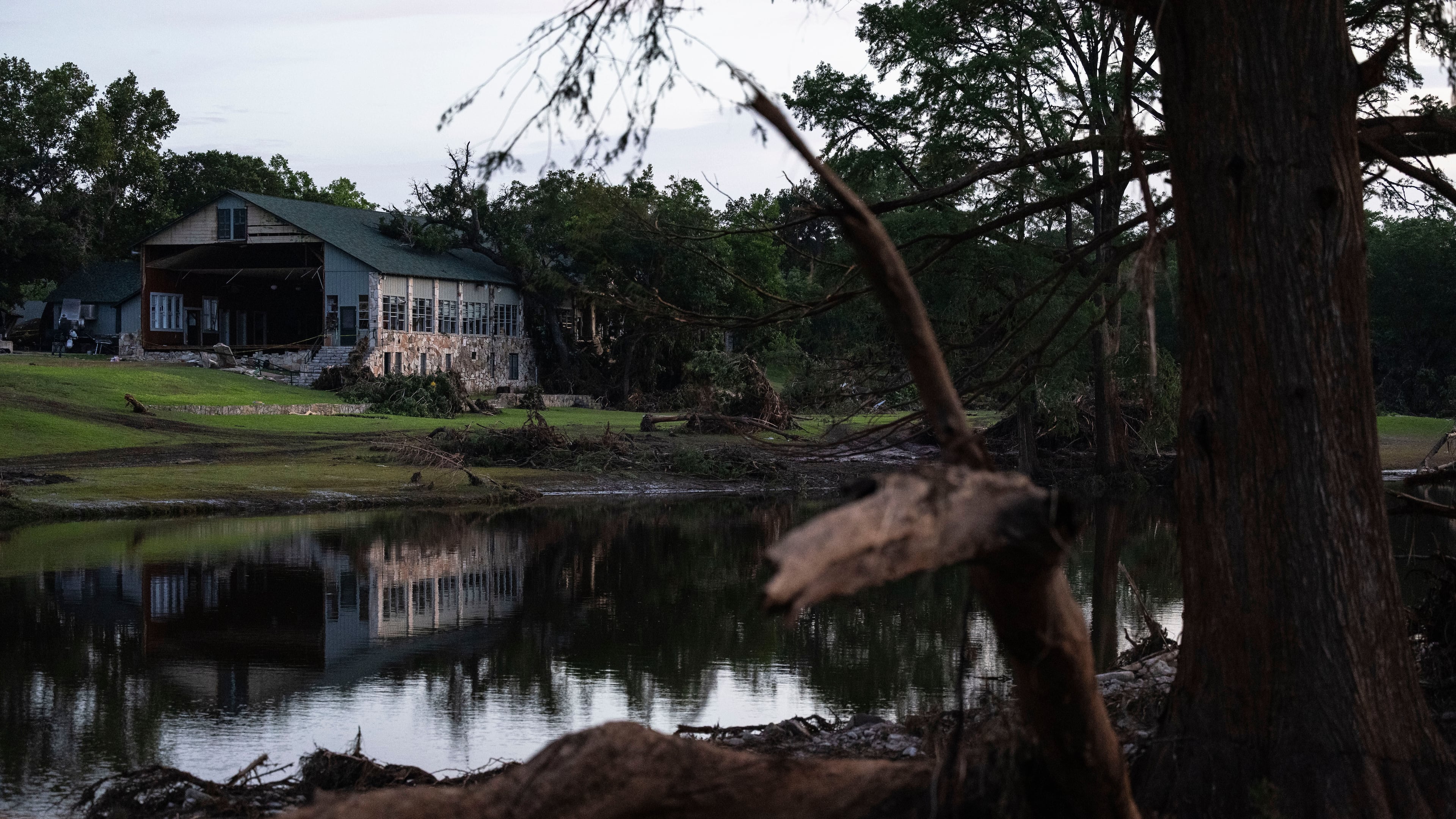 FILE - A building at Camp Mystic is reflected in water after a flash flood swept through the area, July 7, 2025, in Hunt, Texas. (AP Photo/Eli Hartman, File)