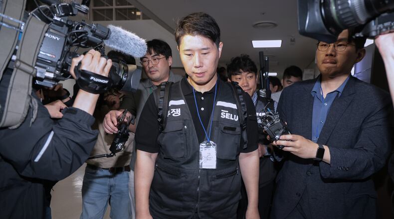 Choi Seung-ho, a leader of the Samsung Electronics labor union, leaves after attending the government-led mediation talks with management at the National Labor Relations Commission office in Sejong, South Korea, Wednesday, May 20, 2026 (Yonhap via AP)