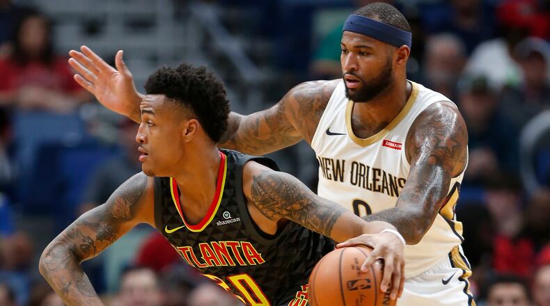 Atlanta Hawks forward John Collins (20) drives past New Orleans Pelicans forward DeMarcus Cousins (0) during the first half of an NBA basketball game in New Orleans, Monday, Nov. 13, 2017. (AP Photo/Tyler Kaufman)