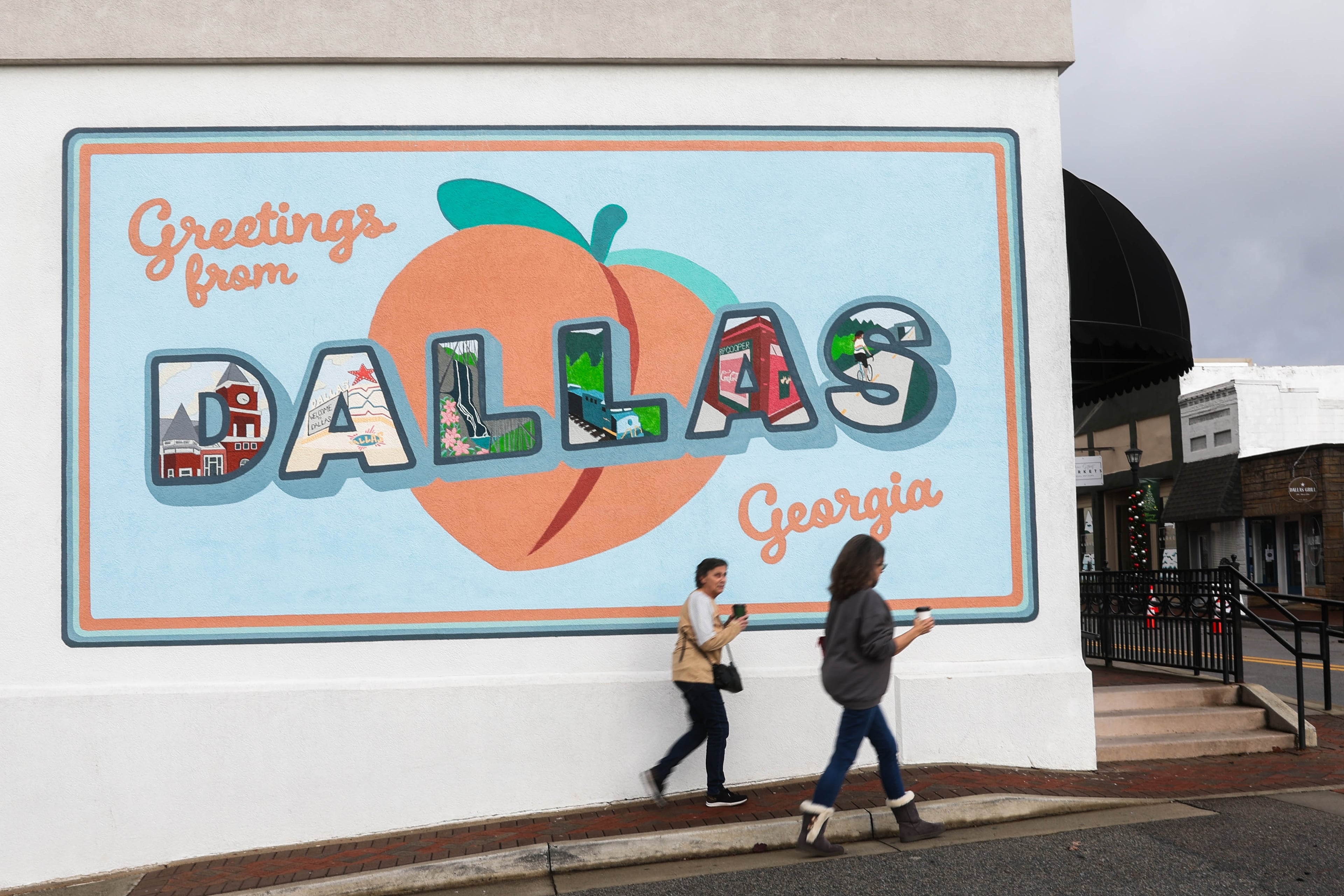 Pedestrians walk through a quiet downtown Dallas on Saturday, Nov. 22, 2025, the day after Marjorie Taylor Greene announced she would be resigning from Congress. Dallas is the county seat of Paulding County, and sits in the congresswoman's district. (Abbey Cutrer/AJC)