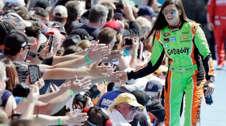 Danica Patrick greets fans as she is introduced before the start of the Daytona 500 NASCAR Sprint Cup series auto race at Daytona International Speedway in Daytona Beach, Fla., Sunday, Feb. 22, 2015. (AP Photo/John Raoux)