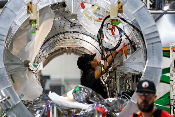 A mechanical engineer is seen working on the Quarterhorse MK 2 aircraft at Hermeus’s Doraville facility on Tuesday, May 12, 2026. Hermeus, a company that specializes in supersonic aircraft, plans to conduct its third test of an uncrewed, remotely piloted aircraft this coming fall.  (Miguel Martinez/AJC)