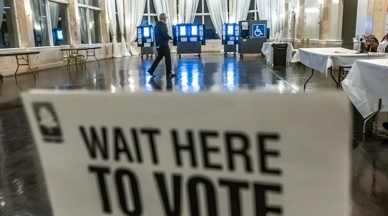 Poll workers stroll through the voting area after the polls open to nearly no one voting at the polling place at the Park Tavern located at 500 10th Street NE in Atlanta on Tuesday, March 12, 2024. Georgia voters encountered light turnout and no lines for the presidential primary today as they made their voices heard about their choices to lead the country. Even though it’s already clear who will win each party’s nominations, voters said it was important to get out and vote. All registered voters were eligible to participate in either the Democratic or Republican primaries, headlined by President Joe Biden and former President Donald Trump. But there were many other potential contenders to choose from as well. Voters could pick from 11 Republicans or three Democrats. All votes will count, including ballots cast for candidates who have dropped out or suspended their campaigns. (John Spink / John.Spink@ajc.com)