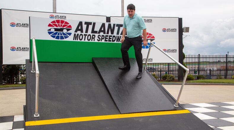 Tyler Head stands on the mock-up showing the difference between the old track and the planned new changes to the Atlanta Motor Speedway Tuesday, July 6, 2021, in Hampton. (Steve Schaefer/For the AJC)
