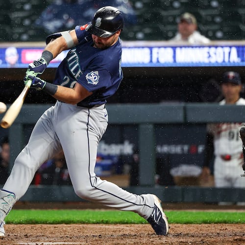 Seattle Mariners designated hitter Cal Raleigh hits a two-run home run against the Minnesota Twins during the eighth inning of a baseball game, Monday, April 27, 2026, in Minneapolis. (AP Photo/Matt Krohn)