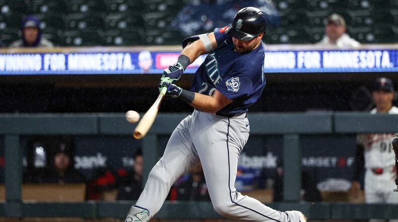 Seattle Mariners designated hitter Cal Raleigh hits a two-run home run against the Minnesota Twins during the eighth inning of a baseball game, Monday, April 27, 2026, in Minneapolis. (AP Photo/Matt Krohn)