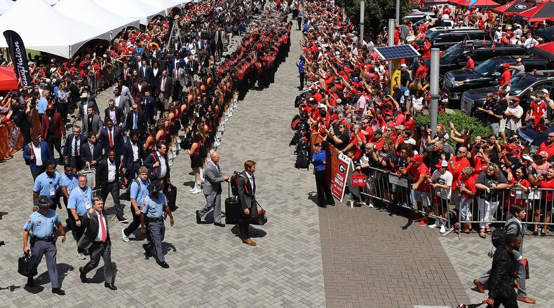 Head coach Kirby Smart (bottom left) flashes a thumbs up as the Georgia football team arrives to the cheers of thousands of Georgia fans during the team walk into Mercedes-Benz Stadium to play Oregon in a NCAA college football game on Saturday, Sept. 3, 2022, in Atlanta.  Curtis Compton / Curtis Compton@ajc.com