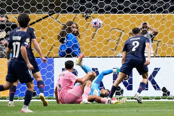Paris Saint-Germain's Achraf Hakimi, right, scores his side's fourth goal during the Club World Cup round of 16 soccer match between PSG and Inter Miami in Atlanta, Sunday, June 29, 2025. (AP Photo/Brynn Anderson)