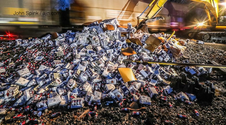 The collision just west of downtown McDonough split the big rig in half and spilled cases a quarter-mile down the tracks.