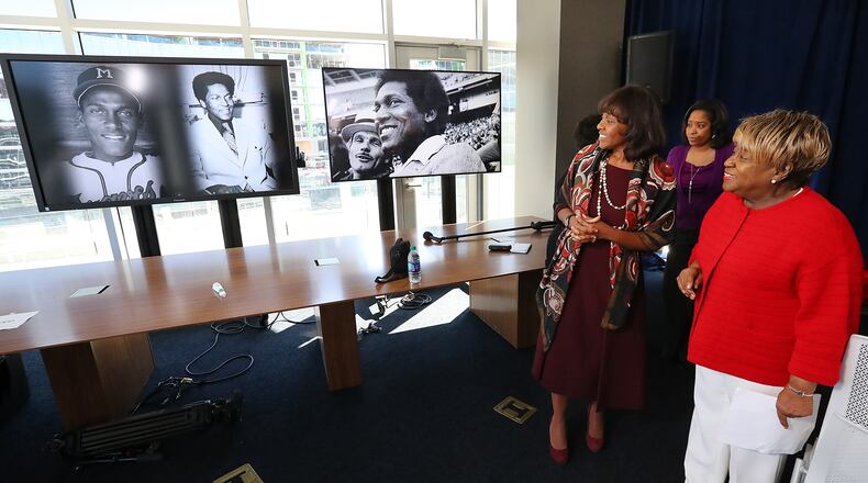February 9, 2017, Atlanta: Rubye Lucas (right), the widow of Bill Lucas, and Wonya Lucas (left), one of their daughters, look over historic photographs of him while the Braves hold a ceremony namig the baseball operations conference room after Lucas, baseball's first African-American general manager, on Thursday Feb. 9, 2017, in Atlanta. The dedication coincides with the 40th anniversary of Lucasâ first season as vice president of player personnel, which made him the first African-American to oversee a player personnel department in baseball and the highest ranking African-American in Major League Baseball at the time.   Curtis Compton/ccompton@ajc.com