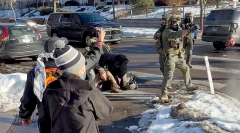 This image taken from video by Max Shapiro shows Alex Pretti, center left, scuffling with federal immigration officers in Minneapolis on Jan. 13, 2026. (Max Shapiro via AP)
