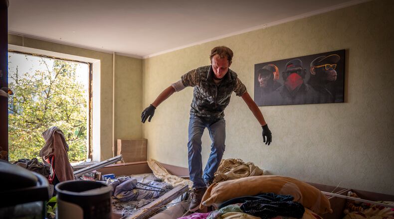 A man inspects damage to his apartment after a Russian missile exploded near his home in Kyiv, Ukraine, Thursday, Sept. 17, 2026. (AP Photo/Dan Bashakov)