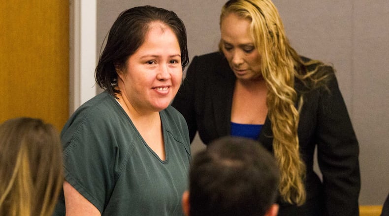 Isabel Martinez, center, enters the courtroom during her arraignment at the Gwinnett Justice and Administration Center in Lawrenceville, Georgia, on Monday, April 16, 2018. Martinez is pleading not guilty to killing her husband and four of her children in July 2017.