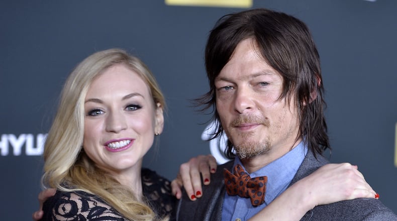 UNIVERSAL CITY, CA - OCTOBER 03: Actors Emily Kinney (L) and Norman Reedus arrive at the premiere of AMC's "The Walking Dead" 4th season at Universal CityWalk on October 3, 2013 in Universal City, California. (Photo by Frazer Harrison/Getty Images)