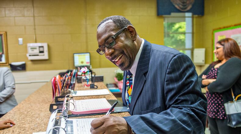 Steven Green, the new superintendent for Dekalb County schools, signs the visitors log before touring a DeKalb elementary school in this AJC file photo.