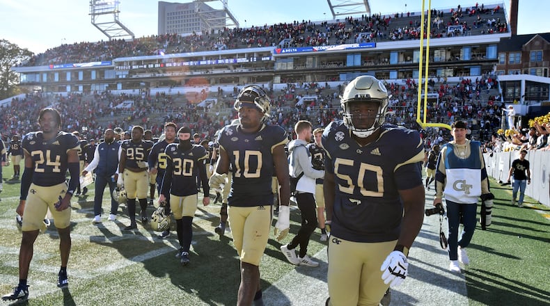 Georgia Tech players leave the football field after Georgia won 45-0 in Atlanta on Saturday, November 27, 2021.  (Hyosub Shin / Hyosub.Shin@ajc.com)