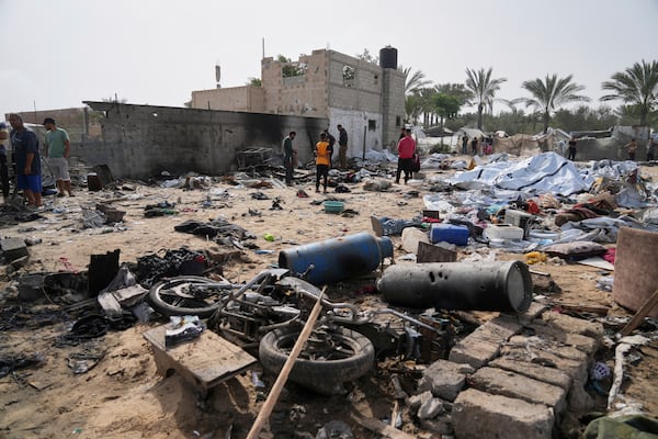 Palestinians inspect the site destroyed by Israeli airstrikes in Khan Younis, Gaza Strip, Sunday, May 18, 2025. (AP Photo/Abdel Kareem Hana)
