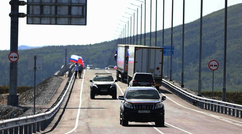 In this photo released by the Government of Primorsky Krai Region on Monday, Sept. 7, 2026, vehicles drive across the new bridge between Russia and North Korea named after the Soviet officer Yakov Novichenko, who is credited with saving North Korea's founding leader, Kim Il-sung, over the Tumannaya River in Primorsky Krai Region of Russia. (Dmitry Ignatenko/Government of Primorsky Krai Region via AP)