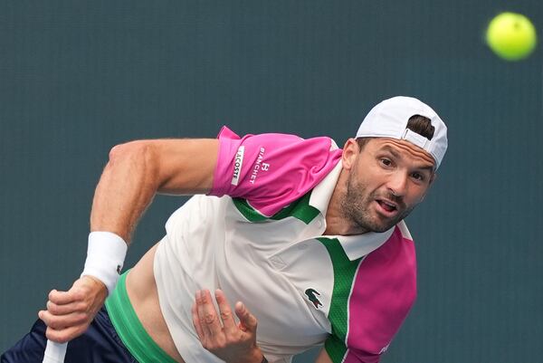 Grigor Dimitrov, of Bulgaria, serves during his semifinal match against Novak Djokovic, of Serbia, at the Miami Open tennis tournament, Friday, March 28, 2025, in Miami Gardens, Fla. (AP Photo/Rebecca Blackwell)