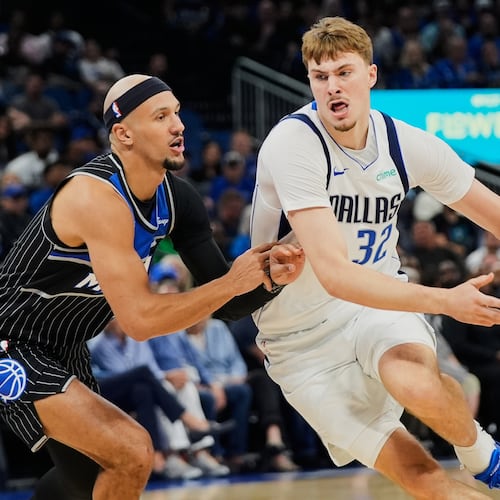Dallas Mavericks forward Cooper Flagg (32) drives past Orlando Magic guard Jalen Suggs, left, during the first half of an NBA basketball game, Thursday, March 5, 2026, in Orlando, Fla. (AP Photo/John Raoux)