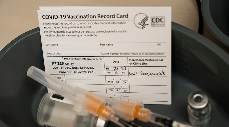 Doses of the Pfizer COVID-19 vaccine and vaccination record cards await patients at UW Medical Center - Roosevelt on June 21, 2022, in Seattle. (David Ryder/Getty Images/TNS)