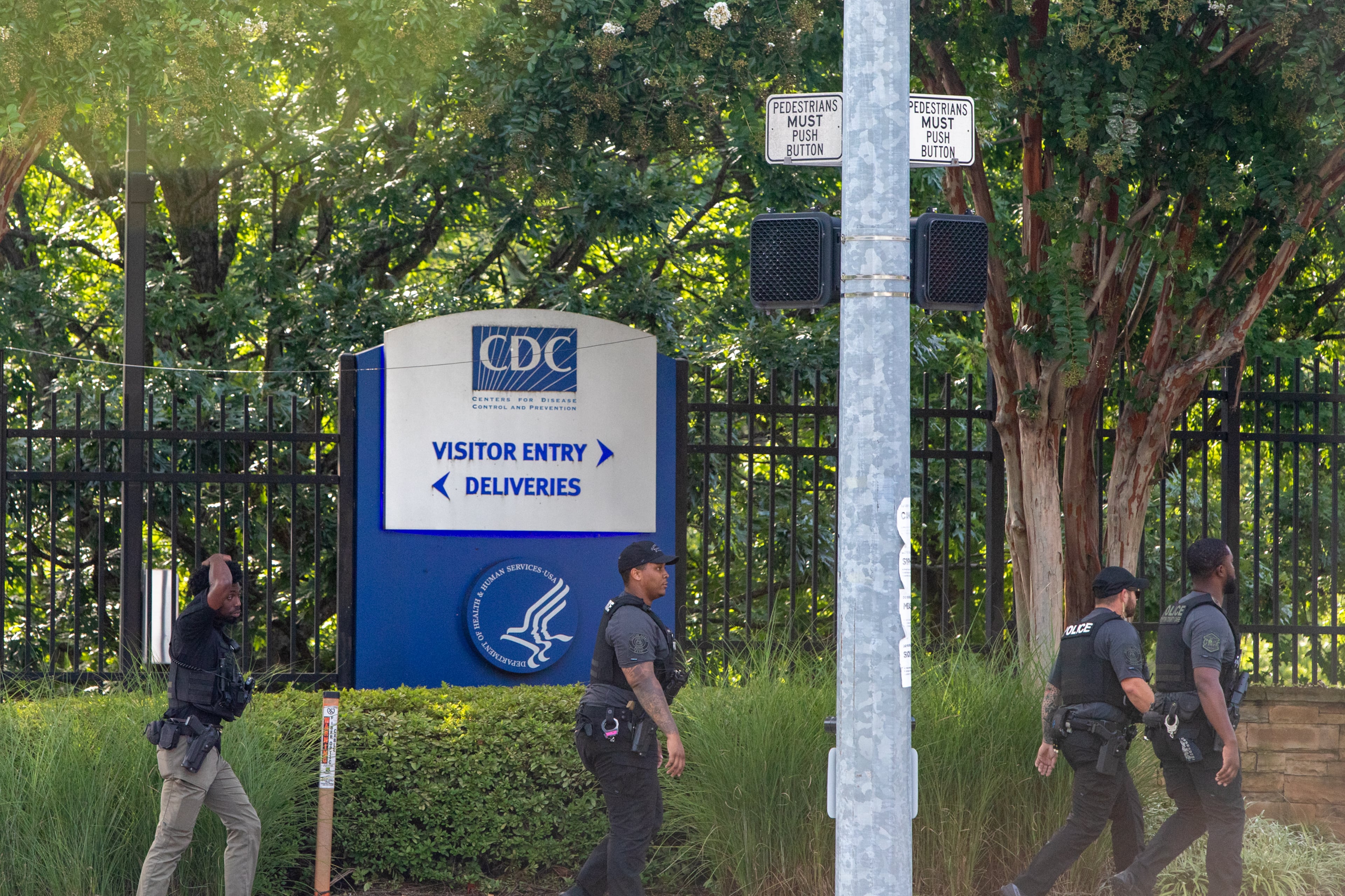 SWAT law enforcement responds to an "active shooter" situation on Clifton Road near the CDC main entrance and Emory Point, which has housing for many Emory students, shopping, restaurants a CVS and day care center, on Friday, Aug 8, 2025. (Jenni Girtman for The Atlanta Journal-Constitution)