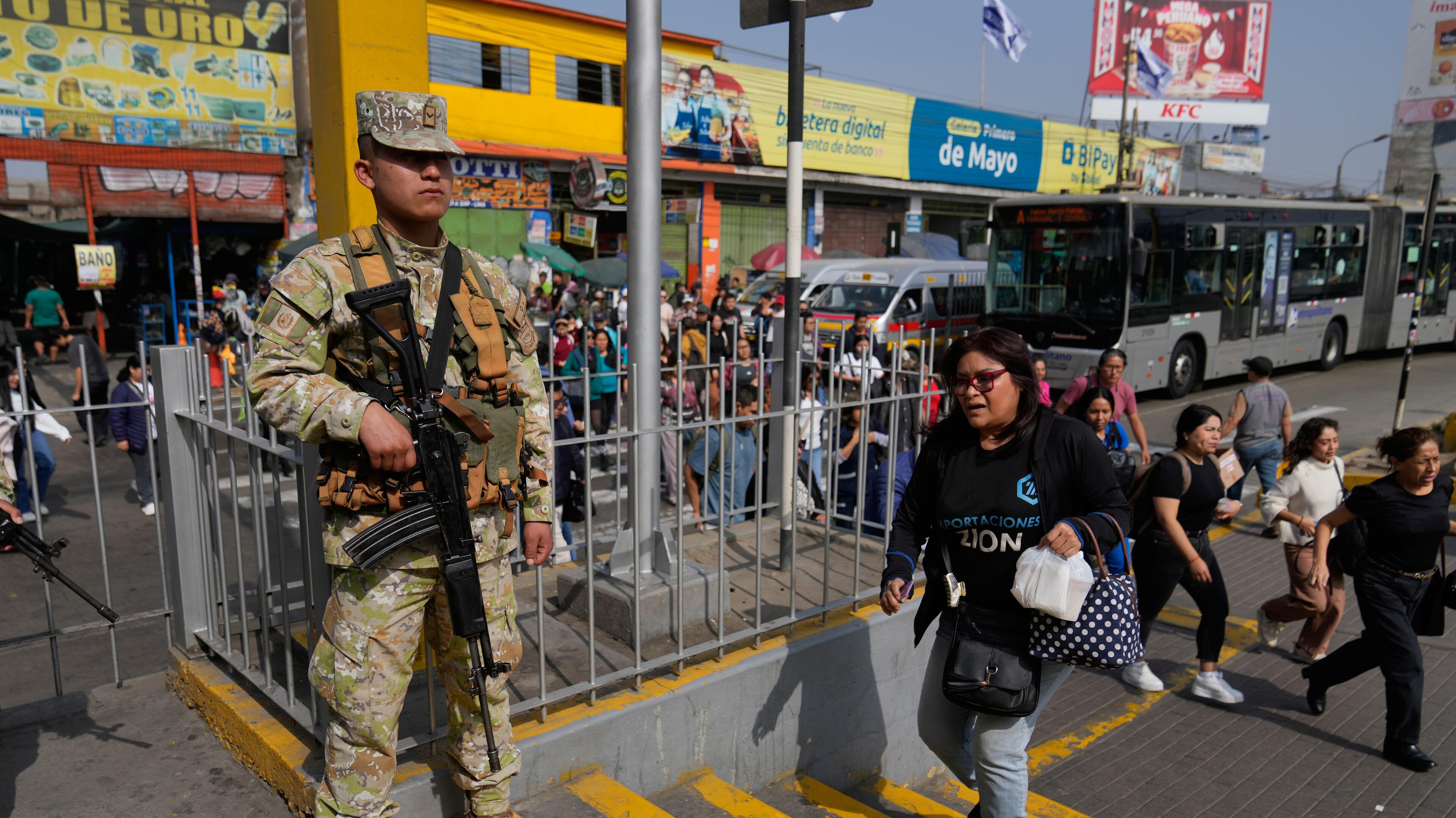 A soldier stands guard at a bus stop in Lima, Peru, Wednesday, Oct. 22, 2025, after President Jose Jeri declared a state of emergency. (AP Photo/Martin Mejia)