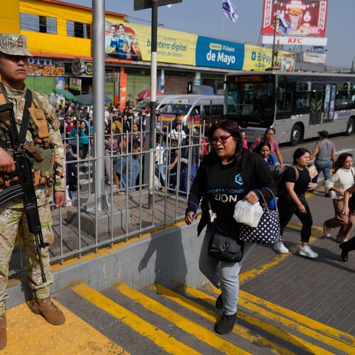 A soldier stands guard at a bus stop in Lima, Peru, Wednesday, Oct. 22, 2025, after President Jose Jeri declared a state of emergency. (AP Photo/Martin Mejia)