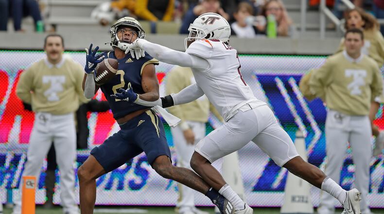 Georgia Tech's Kyric McGowan (2) makes a touchdown reception ahead of Virginia Tech defensive back Chamarri Conner during the first half of an NCAA college football game against Saturday, Oct. 30, 2021, in Atlanta. (AP Photo/Ben Margot)