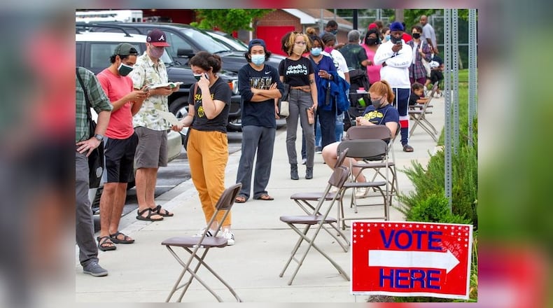 Voters wait in a line Tuesday that stretched around the Metropolitan Library. STEVE SCHAEFER FOR THE ATLANTA JOURNAL-CONSTITUTION