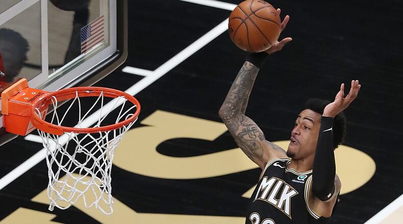 Atlanta Hawks forward John Collins soars to the basket Thursday, March 18, 2021, at State Farm Arena in Atlanta. (Curtis Compton / Curtis.Compton@ajc.com)