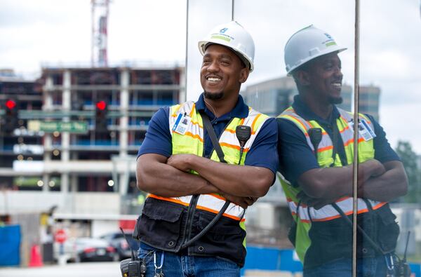 Nicholas Holmes, 39, a foreman for Anning-Johnson Co., stands in front of an Atlanta-area construction site where he’s been working. After a series of tussles with the law, he walked out of Montgomery State Prison six years ago hoping to turn his life around. He got help from training programs and a hot job market. (Casey Sykes for The Atlanta Journal-Constitution)