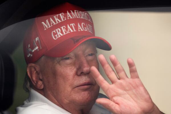 President Donald Trump waves to supporters from his limousine as he arrives at Trump International Golf Club, Saturday, March 29, 2025, in West Palm Beach, Fla. (AP Photo/Manuel Balce Ceneta)