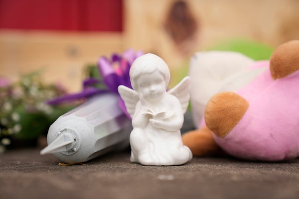 Flowers and other gifts are left at the scene after a car barreled through a building used for an after-school camp Tuesday, April 29, 2025, in Chatham, Ill. (AP Photo/Erin Hooley)