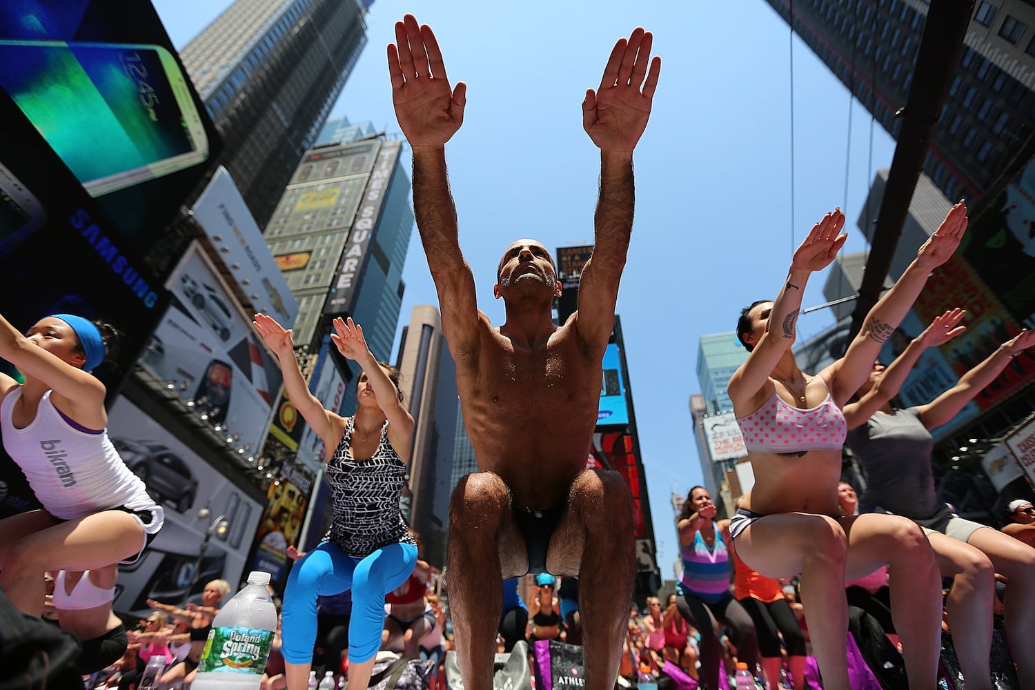 Enthusiasts perform yoga in Times Square to mark summer solstice, June 21, 2013