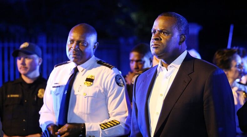 Former Atlanta Mayor Kasim Reed and then Police Chief George Turner stand in the street meet with protesters outside the Governor's mansion during a Black Lives Matter demonstration in 2016. Curtis Compton /ccompton@ajc.com